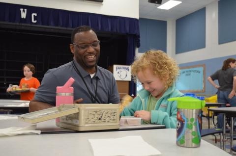 Tesnatee Gap Principal Octavius Mulligan shares a laugh with kindergartner Raleigh Brode in the cafeteria. SAMANTHA SINCLAIR/White County News
