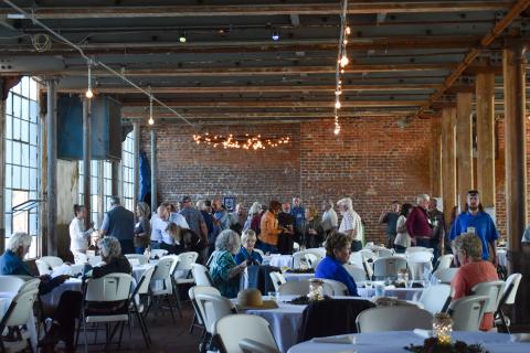 Guests mingle during the social hour at the Soque River Watershed Association Soirée on Saturday evening, talking with  longtime friends, enjoying a drink or looking at the items being raffled off. EMMA MARTI/Staff