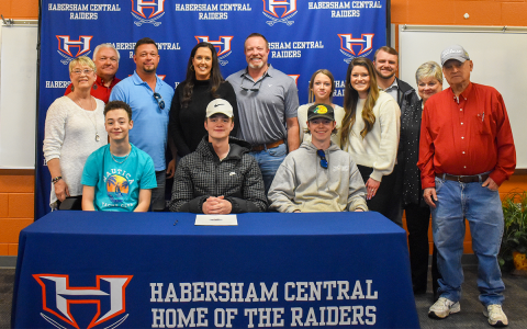 Joining Braydon Wright at his signing ceremony Wednesday are (seated, from left) brother Jaxson Wright, Braydon and brother Landon Wright. Standing are (from left) grandmother Deborah Wright, grandfather Steve Wright, father Andy, mother Michelle, George Alexander, sister Mia Wright, sister Katelyn Wade, Wade’s fiance Trevor Burton, Vicki Harron and Weldon Harron. EMMA MARTI/Staff
