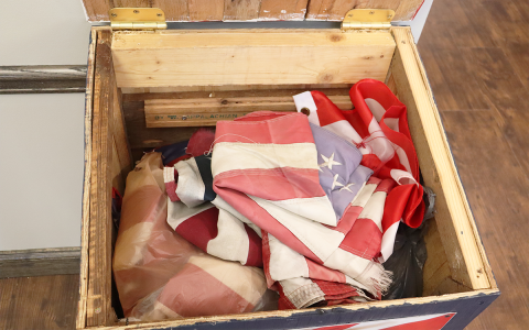 The red, white, and blue flag retirement box located inside the Habersham County Administration Building lobby is shown before completely filling with flags dropped off by residents, businesses, and schools for proper retirement. HABERSHAM COUNTY/Submitted