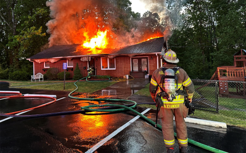Habersham County Emergency Services Battalion Chief Michael Alexander monitors the effectiveness of the firefighting operations at the Hollywood Baptist Church pastorium Monday morning. HABERSHAM COUNTY/Submitted