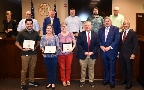 Shown are (front row, from left) Alex Wimberly, IT Specialist II; Tracy Williamson, IT Director; Diana Gallegos, IT Administrator; and Superior Court Judges Rusty Smith, Bill Oliver and Chan Caudell. Back row are (from left) County Manager Alicia Vaughn and Commissioners Bruce Palmer, Bruce Harkness, Ty Akins, Dustin Mealor and Jimmy Tench. Alvin Stinnett, IT Specialist,  also was recognized. MATTHEW OSBORNE/Staff