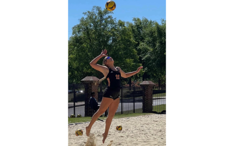 Mercer University’s Katy Corbett serves during a beach volleyball match. Corbett was a three-sport star at Tallulah Falls. BRANDY CORBETT/Submitted