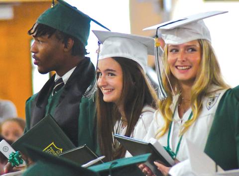 With fellow graduate Frankey Moree, Tallulah Falls seniors Meredith Morris and Madeline Mullis share a laugh during the May 19 ceremony. ENOCH AUTRY/CNI News Service
