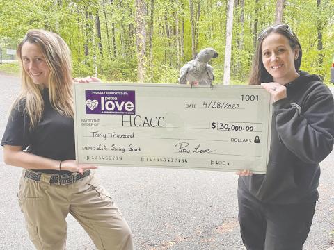 Habersham County Animal Care and Control Director Madi Nix and Administrative Assistant Olivia Whitfield, and “Bird” are shown with the symbolic grant check.