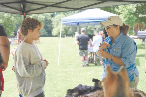 Kyra Purdee (left) speaks with Georgia DNR Interpretive Ranger Kathy Church about the Eastern Garter Snake, among other snakes, which were brought out for the Soque River Festival on June 24. ZACH TAYLOR/Special