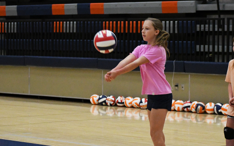 Bailey Worley bumps a ball back to instructors Thursday morning. LANG STOREY/Staff