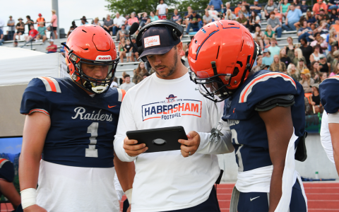Hayes Gunn (left) and Micah White consult with assistant coach Jordan Banks during the Raiders’ preseason win over East Hall. Habersham Central hosts Stephens County at 7:30 p.m. Friday. TOM ASKEW/Special