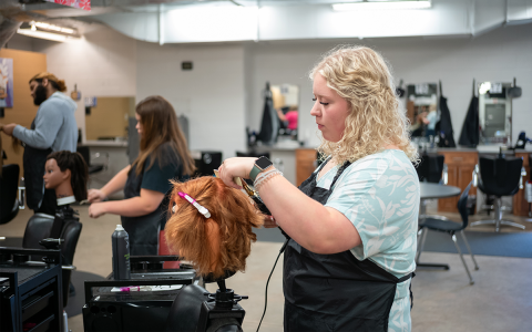 Alizye Jarrard works to put clips in the correct sections of hair at Habersham Central High School on Thursday. ZACH TAYLOR/Special