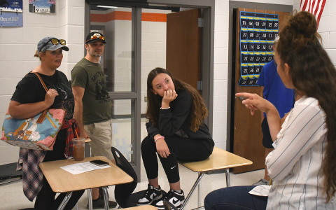Habersham Central math teacher Trailly Holland catches up with student Madison Turner and parents April and Stuart Baker. JOHN DILLS/Staff