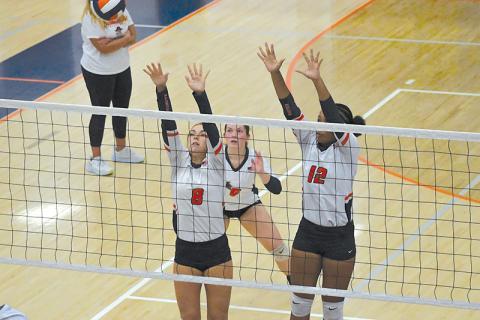 Habersham Central's Laci Fitzgerald, Brooke Blackburn and Da'Riyah Bell look to block at the net against Seckinger. LANG STOREY/Staff
