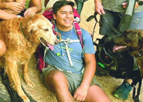 Bryan Santana and Prince are happy to have safely reached the end of their hike with help from some new friends. SUBMITTED