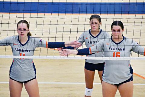 Habersham Central’s Jayden Jarrett (11), Ava Saxon and Callyn Chosewood (16) await a serve during a recent home match.
