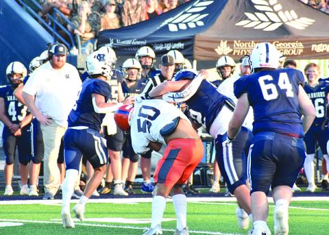 Habersham Central’s Alex Ethridge (50) gets “held” up on his way to White County quarterback Tripp Nix during last Friday’s game in Cleveland. Nix threw a touchdown on this play.  MATTHEW OSBORNE/Staff