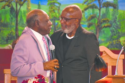 Bishop Ernest Burns (right) of Shady Grove Baptist Church in Cornelia confers with Elder Leon Bradshaw during a service Sunday to celebrate Burns’ 25th year as pastor. MATTHEW OSBORNE/Staff