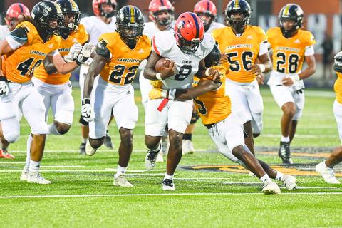 Habersham Central’s Antonio Cantrell drags a Central Gwinnett tackler last Friday night. TOM ASKEW/Special