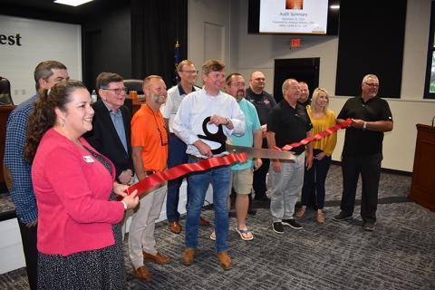 Demorest Mayor Jerry Harkness cuts the ribbon Tuesday at the new Demorest Municipal Conference Center inside the city hall building. Shown are (from left) Chamber of Commerce President Ellie Van Doonum, Councilmen Shawn Allen, Dr. John Hendrix and Donnie Bennett, Chamber Board President Clayton Foster, Councilman Andrew Ferguson, Fire Chief Jonathan Kinght, Assistant Police Chief Casey Chastain, City Manager Mark Musselwhite, City Clerk Megan Chastain and Howard Bell from ACG. MATTHEW OSBORNE/Staff