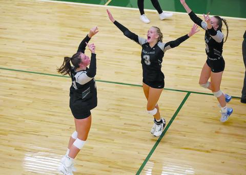 Tallulah Falls’ Addy McCoy, Claire Kelly and Chesney Tanksley celebrate a point during a recent home match. AUSTIN POFFENBERGER/Special