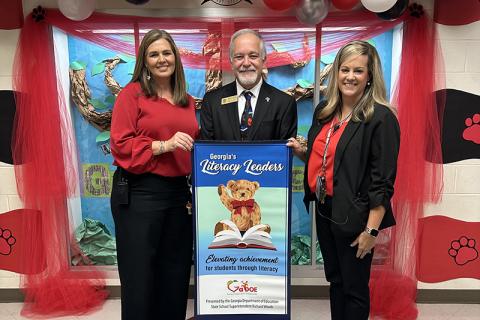 Level Grove Elementary School Principal Aimee Shedd (left), Georgia School Superintendent Richard Woods (center), and Level Grove Assistant Principal Stefanie Eaton (right), celebrate the school’s recognition as a “Literacy Leader.” SUBMITTED