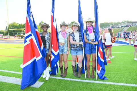 From left, Amayah Dooley, Maggie Vena, Brooke Blackburn and Kyia Barrett helped carry the flags when the Raiders ran out on the field for the season opener against Stephens County. TOM ASKEW/Special