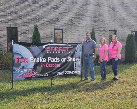 From left, Service Advisor Chris Howland, Owner Nicole Barrett, and Service Advisor Jessica Barrett stand with the Brakes for Breasts sign at Barrett Automotive. SUBMITTED