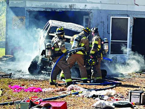 Habersham County firefighters check the engine compartment of the burning truck on Sutton Road in the Fairview community. HABERSHAM COUNTY/Submitted