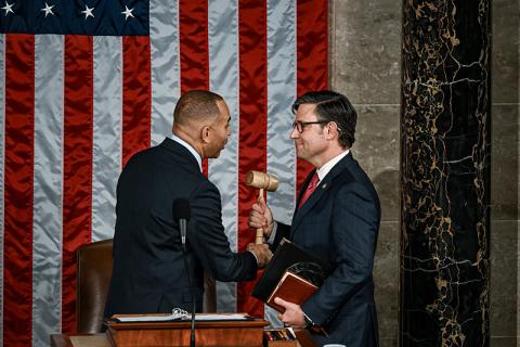 Speaker Mike Johnson is handed the gavel on Wednesday. THE NEW YORK TIMES