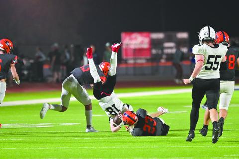 Habersham Central’s Carter Barrett (23) and Keller Green upend Jackson County’s Slade  Swierczek during their last home game. TOM ASKEW/Special
