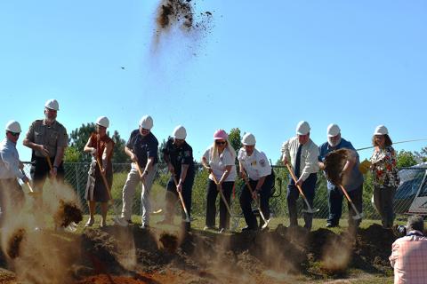 Members of the Habersham County government and first responders and emergency service workers break ground at Ruby Fulbright Aquatic Center, the symbolic site of the new public safety radio system in the county. From left are Sheriff Joey Terrell, County Manager Alicia Vaughn, Public Works Director Jerry Baggett, Shawn Benfield, 911 Director Lynn Smith, Emergency Medical Services Director Jeff Adams,  Bruce Harkness, Bruce Palmer and Stephanie Walker. JULIANNE AKERS/Staff