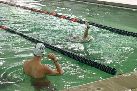 Piedmont swimmer Sam Teed looks on as teammate Will Donaldson swims laps on Monday. The pool was closed for almost two months and the repairs spilled into swim season, canceling the first home meet. Piedmont, Habersham Central and youth swimmers all use the facility for practice as well. LANG STOREY/Staff