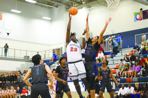 JoJo McCurry lands a hook shot over a defending Chattahoochee forward on Saturday night.  McCurry is a big part of the  Raiders’ plans to take a step forward this season. ZACH TAYLOR/Special
