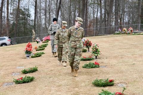 At Saturday’s Wreaths Across America ceremony at the VFW Memorial Park, Josslyn Webber, Zaelice Phasavang and Gabriel Morales ensure each veteran has a wreath placed on their headstone after the ceremony. ZACH TAYLOR/Special