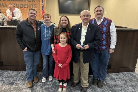 Dr. Robert Barron received his Pioneer in Education award Monday along with family members  (back row, from left) son-in-law Daniel  Ferguson, grandson Cooper Ferguson, daughter Anna Ferguson and son Jeff Barron. In front is granddaughter Emma Ferguson. Other grandchildren not  pictured include  Annalise Gonzalez, James Barron and Conley Barron. MATTHEW OSBORNE/ Staff