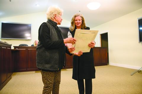 Clarkesville Mayor Barrie Aycock presents a piece of artwork to Leigh Johnston for her work involved with the Clarkesville Bicentennial year, including the mobile history trailer and the Founder’s Gala, which was hosted at Oak Heights in Clarkesville last month. ZACH TAYLOR/Special