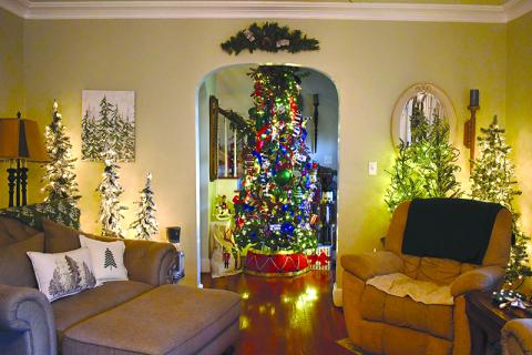 Teri Newsome’s Cornelia home is  as festive as can be, sporting 33  Christmas trees and plenty of  other holiday delights. JULIANNE AKERS/Staff