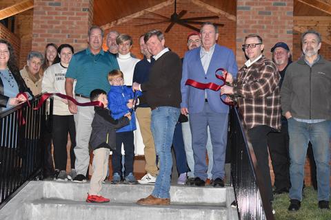 Hunter Harkness and Finn Durden cut the ribbon at Demorest’s new restroom and shelter pavilion in Demorest Springs Park on Wednesday night. Also in attendance (from left) Chamber of Commerce Director Ellie Van Doornum, Lynn Percy, Rachel Pleasant, Brooke Terilli, City Manager Mark Musselwhite, Keith Andrews, Councilman Donnie Bennett, Mayor Jerry Harkness, Councilman Shawn Allen, County Vice-Chairman Bruce Harkness, Randall Roy Fry, Demorest Fire Chief Jerry Palmer and Guy Ramos. MATTHEW OSBORNE/Staff 