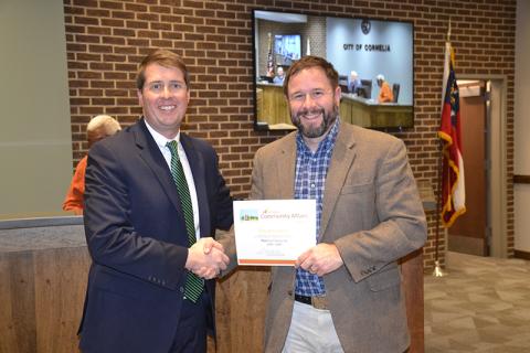 Cornelia Mayor John Borrow receives a certificate naming the city a PlanFirst Community for 2024-26 from Daniel Gaddis from the Department of Community Affairs. DONALD FRASER/Staff
