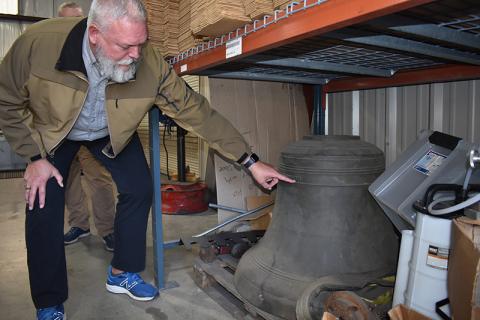 Sheriff Joey Terrell points out the  features of the old courthouse bell that dates to 1924. MATTHEW OSBORNE/Staff