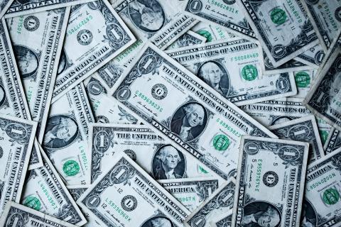 Photo of a pile of cash. Photo by Alexander Grey/Unsplash