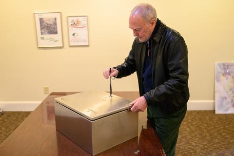 Councilmember Brad Coppedge uses a butter knife to open the time capsule. ZACH TAYLOR/Special