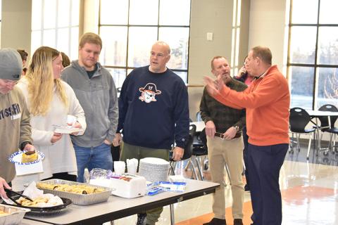 Habersham Central Principal Dr. Jonathan Stribling converses with Assistant Principal Donnie Bennett as teachers (from left) Jeff Wilson, Margaret Greenwald, Shane Hotalen and Matt Hudlow grab some breakfast at an appreciation meal put on by parents Tuesday morning at the school. MATTHEW OSBORNE/Staff