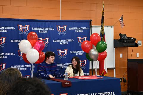 Habersham Central High School seniors Micah Zack and Kate Navarro share a laugh at Wednesday’s scholarship presentation. JULIANNE AKERS/Staff