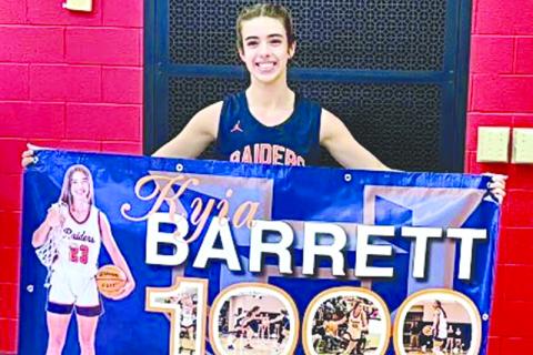 Kyia Barrett shows off her banner commemorating her 1,000th point. SUBMITTED