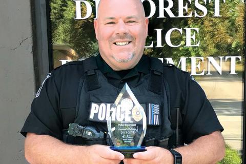 Former Demorest Police Chief Robin Krockum shows off the department’s award for best highway safety in the state in 2018-19. FILE