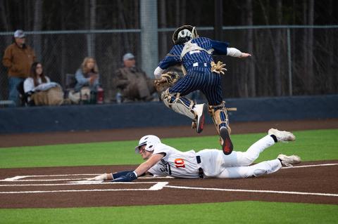 Hayden Gailey slides underneath Elbert County catcher Camden Bryant to put the Raiders ahead of the Blue Devils in the bottom of the 4th of Game 1. ZACH TAYLOR/Special