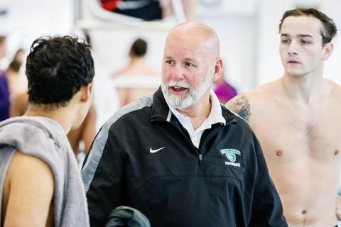 Piedmont swimming coach Teddy Guyer talks with Ross Coppedge (right) and Leandro Forero during a meet this season. SUBMITTED
