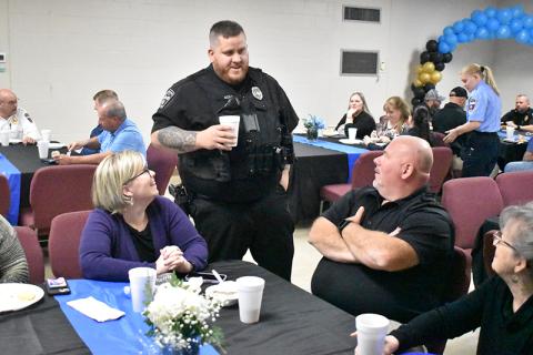 Outgoing Demorest  Police Chief Robin Krockum (seated right) and his wife Meadow talk with Officer Ty Moss at lunch Friday. MATTHEW OSBORNE/Staff