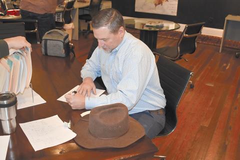Ty Akins signs paperwork to run for a full term as District 5 Commissioner.