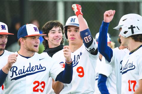 The Raiders celebrate with  Konnor Burrell after he hit a  two-run home run in the bottom of the 5th  inning against Apalachee last week. ZACH TAYLOR/ Special