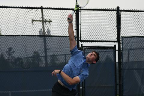 Habersham’s Josh Burris slams a serve in Wednesday’s state match against Newnan. LANG STOREY/Staff